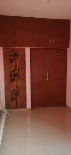 Reddish brown wall-mounted PVC cupboard with overhead loft storage