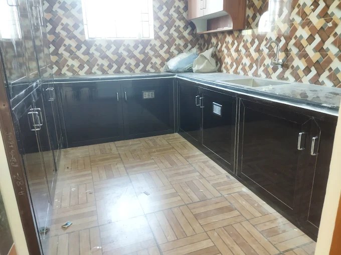 Premium black glossy modular kitchen completed by Deepalaxmi team