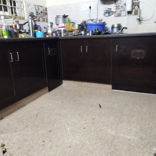 Dark modular kitchen with base cabinets and overhead shelves